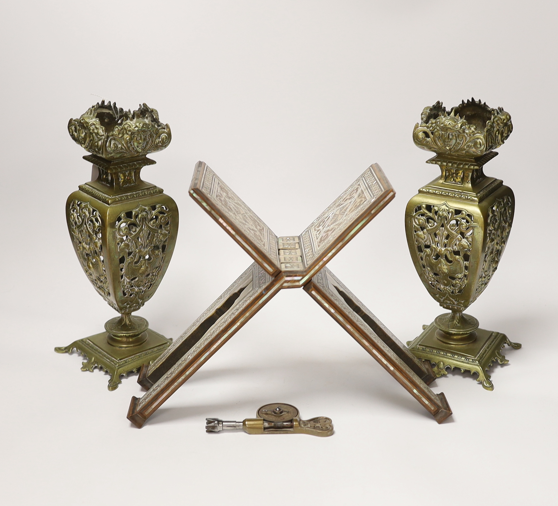 A pair of early 20th century brass garnitures, a German brass tachometer and a mother of pearl inlaid Quran stand, tallest 25cm